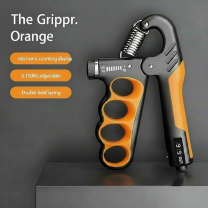 Orange and black mechanical counting gripper on a dark background