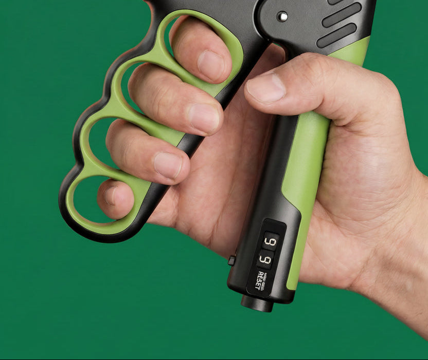 Hand holding a green and black grip strengthener against a green background